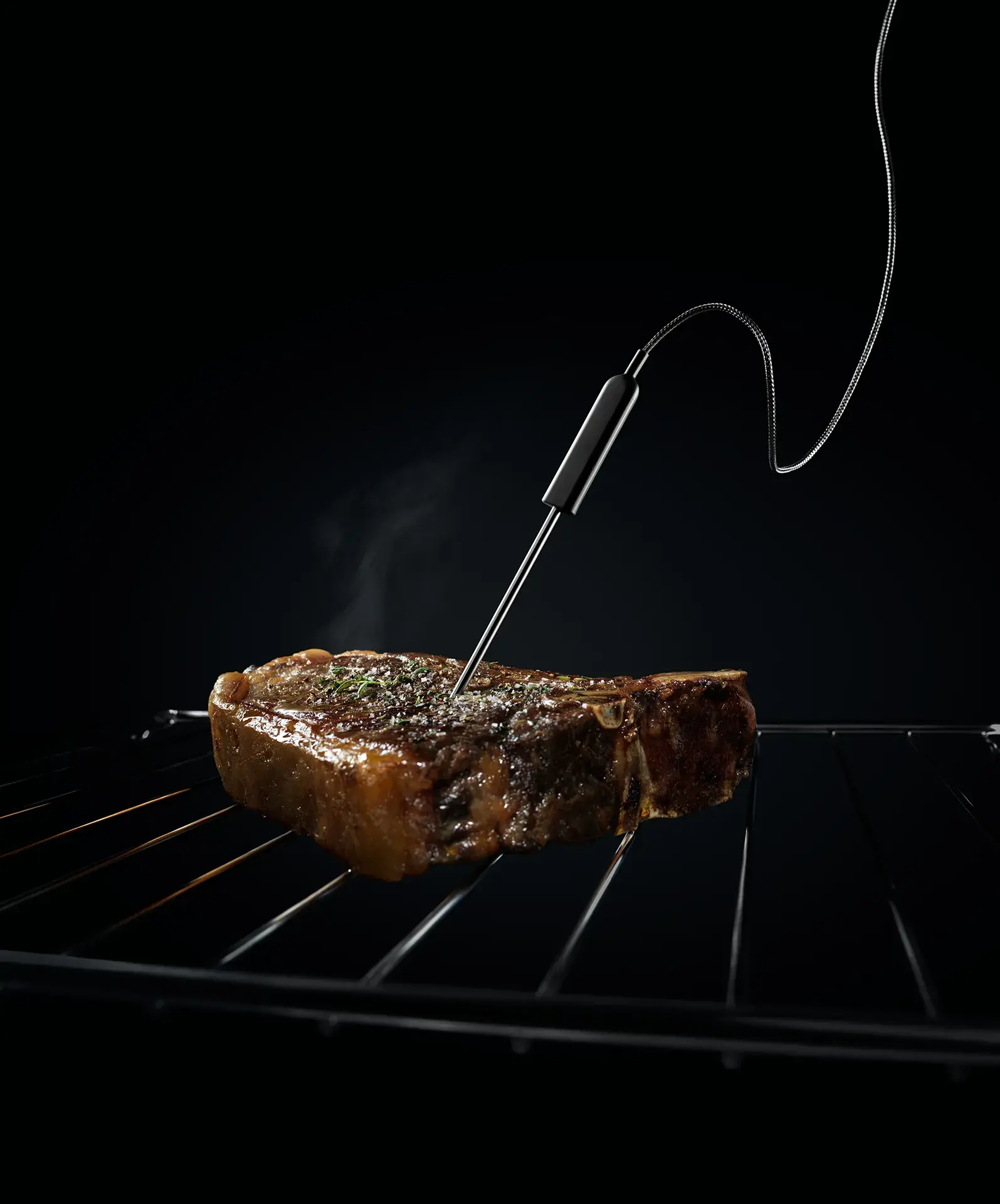 Steak mit Gargutsensor auf einem Rost. 